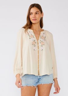 [Color: Natural/Pink] A front facing image of a brunette model wearing a cream colored bohemian blouse with floral embroidered details. With long raglan sleeves Spring Blouse, Blouse With Long Sleeves, Spring Blouses, Bell Design, Denim Short Dresses, Bohemian Tops, Boho Blouse, Embroidered Details, Tank Top Camisole