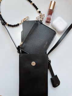 Artfully organize your belongings with THE CÆP's Mate Mini Crossbody. We believe the Mini Mate is the perfect accessory for basically any activity! Crafted with vegan leather, this chic accessory features an adjustable strap (19" min. drop, 23" max. drop), a main compartment that fits all phones with slim cases plus other essentials, an interior back pocket for cards and receipts. Plus, it has a ring for extra clip-on options, magnetic closure, and light gold hardware. Measurements of the Bag: W Wrist Wallet, Black Vegan, Chic Accessories, Mini Crossbody, Rope Chain, Slim Case, Magnetic Closure, Gold Hardware, Anklets