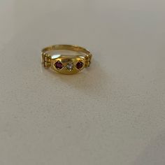 Antique 18k Garnet Diamond Gypsy Ring From Birmingham C 1901. This Yellow Gold Edwardian Ring Features Two Round Cut Garnets And One European Cut Diamond In A Marquis Setting. The Shoulders Of This Antique Ring Have A Columnar Architecture To Them. Ring Is Sized To 6 3/4; There Is A 18k Stamp Inside. Antique Multi-stone Yellow Gold Cluster Ring, Victorian Multi-stone Yellow Gold Rings, Antique Multi-stone Cluster Ring In Yellow Gold, Heirloom Yellow Gold Multi-stone Diamond Ring, Antique Multi-stone Gold Diamond Ring, Victorian Multi-stone Yellow Gold Diamond Ring, Vintage Yellow Gold Three-stone Jewelry, Classic Gold Three-stone Rings, Vintage Yellow Gold Three Stone Jewelry