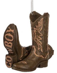 two brown cowboy boots hanging from a chain