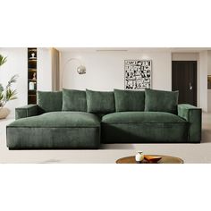 a large green couch sitting in a living room