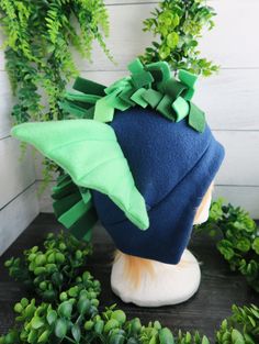 a blue and green hat sitting on top of a head