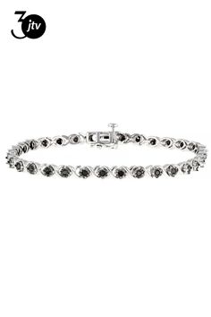 0.90ctw round black diamond, rhodium over sterling silver tennis bracelet. Measures approximately 7"L x 1/8"W and has a hidden box clasp. Black rhodium enhanced settings. Black Diamond Bracelet, Silver Tennis Bracelet, Box Clasp, Black Rhodium, Tennis Bracelet, Black Diamond, Diamond Bracelet, Tennis, Bracelet