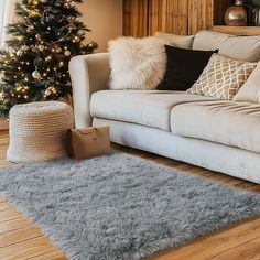 a living room filled with furniture and a christmas tree