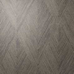 a close up view of a herringbone pattern on a wallpapered surface in grey tones