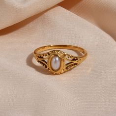 A victorian-inspired beauty and timeless design, the Filigree Pearl Gold Signet Ring is perfect for those special occasions. The lustrous natural pearl is bezel set in a filigree-style signet ring. This gold pearl ring has an heirloom look without the high price tag. DETAILS & SIZE Composition: 18K gold plated over 316L Stainless Steel; Natural pearl Measurements: US ring sizes: 6, 7, 8 Waterproof, tarnish-resistant, and nickel free Learn how to find your ring size here. Or shop Rings for more o Classic Gold Pearl Drop Ring, Classic Gold Pearl Ring With Pearl Drop, Oval Gold Pearl Ring, Vintage Yellow Gold Pearl Ring, Elegant Signet Ring With Intricate Design For Anniversary, Victorian Gold Signet Ring For Wedding, Vintage Oval Pearl Ring For Gift, Vintage Oval Pearl Ring For Wedding, Vintage Oval Pearl Ring Gift