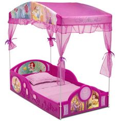 a pink princess bed with canopy and mosquito netting on it's sides, in front of a white background