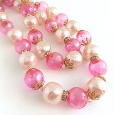 "Hot pink bubble beads and pale pink faux pearls in a double strand choker--perfect for your favorite cocktail dress or caftan! the beads are interspersed with rhinestone ring beads and goldtone filigree fittings. Super fun! 14-1/2\" long with a 3\" adjustable tail. Have even more fun with 2 pink chokers together! (Last photo shows them both) Check out my other listing: https://www.etsy.com/listing/1105538441/pink-pearl-jeweled-choker" Pink Beaded Necklaces For Party, Pink Round Beaded Necklaces For Party, Feminine Pink Pearl Necklace, Pink Pearl Chain Jewelry With Round Beads, Pink Pearl Beaded Necklaces For Parties, Pink Pearl Chain Beaded Necklaces With Round Beads, Pink Pearl Chain Beaded Necklace With Round Beads, Pink Pearl Chain Necklace With Round Beads, Pink Pearl Chain Beaded Necklaces For Wedding