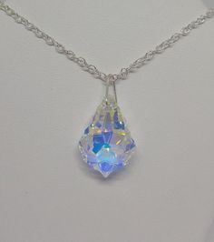 This beautiful clear Aurora Borealis AB Swarovski crystal baroque drop hangs on a sterling silver chain.**Crystal Clear AB (Aurora Borealis) is a shimmering, iridescent rainbow effect that creates an even greater sparkling quality to the base color and reflects varying colors depending on the angle of light. Pick you chain:15" Cable, 18” Cable, 20” Cable, or 20” SnakePendant Size: 22x15mmNecklace is packaged in a white cotton-filled gift box.**Matching Earrings Available**https://www.etsy.com/Su Silver Pendant Crystal Necklace With Jewels, Teardrop Crystal Necklace Gift, Teardrop Crystal Necklace For Gift, Crystal Necklace With Teardrop Pendant For Gift, Gift Teardrop Crystal Necklace, Faceted Drop Silver Crystal Necklaces, Silver Faceted Drop Crystal Necklaces, Silver Fantasy Crystal Necklace Gift, Elegant Handmade Iridescent Crystal Necklace