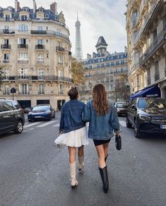 two women walking down the street in paris