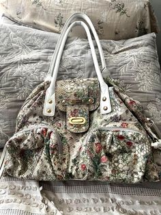 This is a beautiful & quote roomy handbag by Sharif In a great organic floral design! The interior is green poly fabric and is immaculate. It comes with a bonus wallet With ID window inside that is separate. Very handy! The bag is about 17 inches wide and 10 inches tall and features white leather trim and handle as well as the bottom. There are 4 feet on the bottom for resting the bag. The handles are long enough for shoulder wear. Please feel free to ask any questions you have. FINE PRINT: **I do NOT have a pet free home I have two dogs so pet hair is always a possibility on fabric items. If you are allergic keep this in mind. No cats or other pets in the home.                                                     This is a smoke-free home. I only accept returns for items not as described o Floral Print Double Handle Shoulder Bag For Everyday, Everyday Floral Print Shoulder Bag With Double Handle, Everyday Floral Print Double Handle Shoulder Bag, Daily Use Floral Print Satchel Shoulder Bag, Daily Use Floral Print Shoulder Satchel, Floral Print Tote Satchel For Daily Use, Floral Print Double Handle Shoulder Bag For Daily Use, Daily Use Double Handle Shoulder Bag With Floral Print, Daily Use Floral Print Shoulder Bag With Double Handle