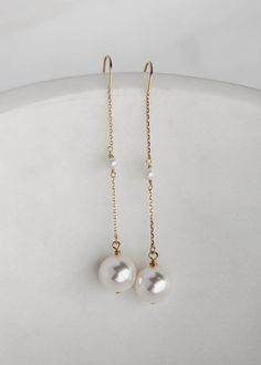 Cecile is a dainty set of pearl drop earrings featuring light-catching Swarovski pearl drops suspended from a fine chain. These delicate details whisper sophistication and style which you will love to wear after your wedding day. * DETAILS * > Designed and handmade in Australia. Worldwide shipping > Swarovski pearls, gold or silver plated settings > Measurement: 65mm * READY TO SHIP * The Cecile earrings are ready to ship. Please allow 5-7 business days for processing plus delivery time Elegant Pearl Bridal Earrings With Pearl Chain, Elegant Pearl Chain Bridal Earrings, Delicate Pearl Chain Dangle Earrings, Delicate Dangle Bridal Earrings With Pearl Pendant, Elegant Long Drop Pearl Pendant Earrings, Pearl White Pearl Drop Linear Earrings, Delicate Bridal Dangle Earrings With Pearl Pendant, Akoya Pearl Drop Dangle Earrings, Minimalist Pearl Chain Earrings For Formal Events