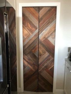 a large wooden door in the middle of a kitchen