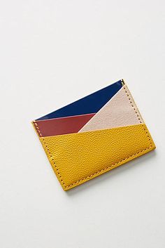 a yellow card holder with a blue, red, and white stripe on the front