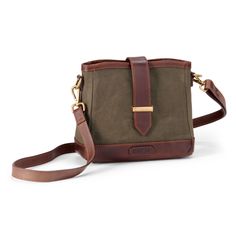 a brown and green cross body bag on a white background with the strap down to it's shoulder