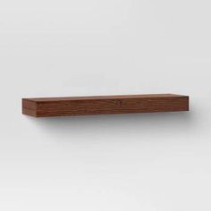 a wooden shelf on the wall with white background