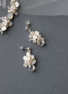 Small ivory flower bridal earrings with Swarovski crystals, Dangle wedding earrings with clear crystal, Stud earrings for bridesmaids A delicate and small ivory flower bridal earrings created of silver color Japanese Toho beads, Swarovski crystals and pearls, handmade Fimo clay flowers, wired with silver wire. 925 sterling silver earring studs. Measures about 0,59 by 1,38 inches /1,5 by 3,5 cm (at its widest part). ♥100% handmade. ♥This item will be ready to ship within 2 business days (shipping White Sterling Silver Crystal Earrings For Wedding, Delicate Silver Flower Earrings For Wedding, Delicate Sterling Silver Cluster Earrings For Wedding, Sterling Silver Dangle Flower Earrings For Wedding, Delicate Sterling Silver Crystal Earrings For Wedding, Dainty Silver Flower Earrings For Wedding, Sterling Silver Flower Earrings For Wedding, Silver Handmade Flower Earrings For Wedding, Silver Handmade Flower Wedding Earrings