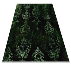 an area rug with green and black designs on it