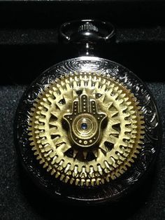 As with every item listed in my shop, the Hamsa Hand Pocket Watch is one of a kind. Each Hamsa Hand pocket watch design is made to order. This listing price is for one Mechanical Pocket Watch. This is a fully functional mechanical pocket watch. This listing is for one mechanical pocket watch in a black case with a black dial and silver numbers. The gears can be seen from inside the watch face as well as through a window in the back of the case. The pocket watch is purchased new and used as a functional canvas for the art. Each watch is roughly 47 mm in diameter (about 2 inches). Each Specialty Mechanical Pocket Watch design is individually crafted. There are no two alike. When you place your order, a pocket watch of similar design will be crafted just for you. We will work with you to desi Luxury Self-winding Watch As A Gift, Metal Round Watch Accessories For Gift, Self-winding Watch With Round Dial As Gift, Timeless Self-winding Watch Accessories As Gift, Self-winding Watch As Gift, Handmade Black Watch As A Gift, Handmade Silver Watch Accessories Gift, Handmade Black Watches As A Gift, Handmade Black Watch For Gift