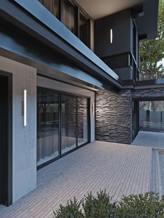 an exterior view of a modern house with large windows