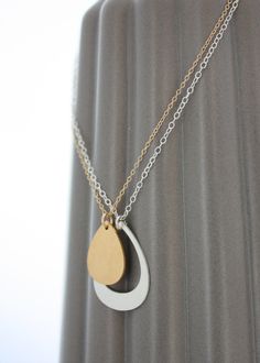 "Nesting droplets represent a bond between mother and daughter that can never be broken. This set includes one necklace for mom and one necklace for daughter. Custom shaped pendants are cut from a single piece of metal, symbolic of the shared connection of mother and child. A uniquely beautiful shape when worn individually; celebrate the bond you share in style. Choose from any combination of sterling silver or 24k gold vermeil- Photo 2 shows the combination silver/gold Photo 4 shows combination Mother Daughter Necklaces, Necklace For Daughter, Mom Gifts Jewelry, Mother Daughter Jewelry, Mother Daughter Necklace, Necklace For Mom, Mother Daughter Gifts, Daughter Jewelry, Wedding Gifts For Bride