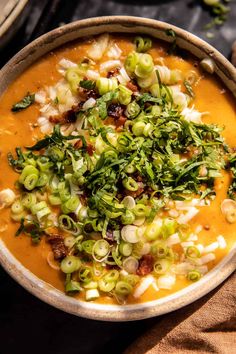 a bowl filled with soup and garnished with green onions