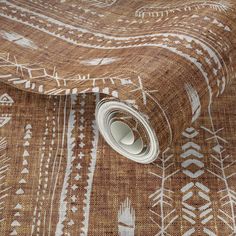 a roll of brown and white patterned fabric