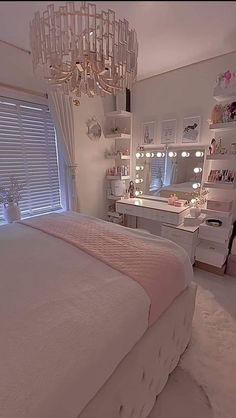 a bedroom with a chandelier hanging from the ceiling and a bed in front of a window