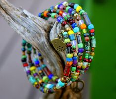 "This Gorgeous colorful beaded memory wire bracelet will always retain its shape & does not require any clasps - its so easy to get on & off the wrist! Just start at one end & wrap it around...it stays in place & couldn't be easier! Adorned with a wide variety of multi-colored Gemstone beads & Czech glass beads, the colors are fabulous! I've topped it off with cute brass charms at each end - a rustic bird on one end & a peace heart on the other...Very Boho Chic! Uniquely Brass Bird, Beaded Memory Wire Bracelets, Beaded Memory Wire, Project List, Memory Wire Bracelet, Rainbow Bracelet, Memory Wire Bracelets, Rainbow Beads, Boho Bracelet