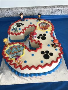 a birthday cake with paw patrol decorations on it's number three shaped like the number five