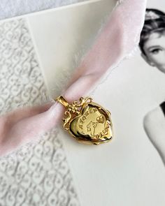 Cupid Locket Choker features a locket adorned with Cupid, a token of love. Comes with a pretty pink soft velvet ribbon. Spread love and style in one swoop! 18k Gold plated silver locket. Elegant Medallion Locket Necklace For Valentine's Day, Elegant Charms Locket Necklace For Mother's Day, Rose Gold Vintage Charm Locket Necklace For Wedding, Elegant Wedding Locket Necklace With Charms, Elegant Locket Necklace With Charms For Anniversary, Elegant Rose Gold Locket Necklace With Vintage Charm, Elegant Vintage Charm Locket Necklace For Valentine's Day, Pink Charm Necklace For Wedding, Pink Charm Necklaces For Wedding