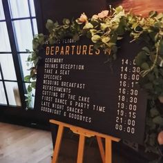 there is a sign that says departures on the board in front of a window