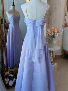 Step into a world of magic and elegance with this stunning Vintage Purple Satin Fairy Dress. The luxurious satin fabric in a dreamy purple hue drapes beautifully, exuding timeless charm and sophistication. The spaghetti straps add a touch of delicate femininity, making it perfect for any enchanting occasion. The highlight of this gown is the whimsical back wings design, adding a fairy-tale-like allure.   Garment Size   	 		 			Size 			XS 			S 			M 			L 			XL 			2XL 		 		 			Bust 			76 			80 			8 Strapless Lavender Dress, Simple Long Purple Dress, Pastel Purple Formal Dress, Periwinkle Dress Aesthetic, Dress Bodice Styles, Vintage Formal Dresses 1950s, Empire Waistline Dress, Draped Back Dress, Dress Draping Ideas