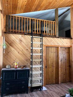 a room with wood paneling and wooden stairs