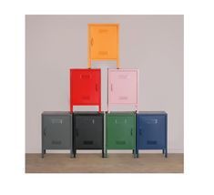 four different colored lockers sitting next to each other in front of a white wall