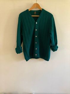 Fabulous vintage Ren-Dale knit cardigan in rich hunter green. The shade was hard to capture, just beautiful in person. Featuring a beautiful striped knit and finished with mother-of-pearl style buttons, this virgin wool cardigan is a perfect staple for spring and fall.  No flaws to note.  Marked a size Medium, I believe this is a men's sweater but would work for any gender.  Visit the Clothes | Shoes | Bags section for more handsome vintage menswear: https://www.etsy.com/ca/shop/LotusRoadVintage?section_id=27662622 Please visit my shop to see more gorgeous quality vintage items for your modern home: https://www.etsy.com/ca/shop/LotusRoadVintage?ref=seller-platform-mcnav Exciting news! Lotus Road Vintage has expanded and has launched a sister shop featuring only vintage print advertising. P Classic Green Wool Cardigan, Vintage Green Knit Outerwear, Green Wool Knitted Cardigan, Vintage Green Cardigan For Fall, Classic Green Textured Knit Sweater, Vintage Green Long Sleeve Cardigan, Vintage Green Knit Cardigan, Vintage Green Knit Tops, Green Vintage Knit Cardigan