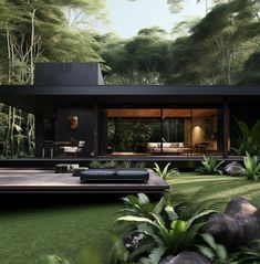 a modern house in the middle of a lush green area with trees and bushes surrounding it