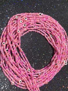 Adorn your waist with these beautiful pink evil eye beads to bring forth body positivity, self love, and healing ✨ Pink Beaded Necklaces With Heart Beads, Pink Beaded Necklaces With Heart-shaped Beads, Pink Jewelry With Colorful Beads For Festival, Festival Letter Beads, Handmade Pink Spiritual Beaded Necklace, Handmade Spiritual Pink Beaded Necklaces, Pink Tiny Beaded Bracelets For Party, Trendy Pink Beaded Necklaces For Summer, Pink Letter Beads Jewelry For Party