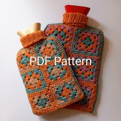 two crocheted hand warmers on top of each other, one with a wooden stopper