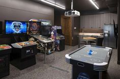 a room filled with lots of different types of video game equipment and games on tables