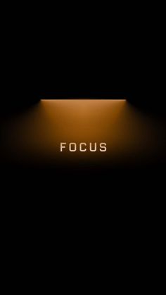 the word focus is lit up in the dark with light coming from it's center