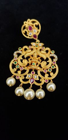 "Stunning Necklace with White, Ruby, Emerald, Pearls and Cubic Zircon. Handmade Indian Temple Jewelry, best to wear it for traditional ceremonies or Indian wedding. This bridal jewelry has ethnic finish. It has Cubic Zircon stones with ruby and emeralds. It is a Bollywood style one gram jewelry. There are long and short patterns of Indian jewelry in Kundan, Pearls, CZ, American Diamond , ruby, emerald, Polki, kemp to suit every occasion of South Indian and North Indian weddings. Handmade Indian Traditional Pendant Temple Necklace For Wedding, Wedding Temple Necklace With Motifs, Bollywood Style Pendant Temple Necklace For Wedding, Temple Necklace With Motifs For Wedding And Diwali, White Pendant Temple Necklace For Wedding, Wedding Temple Necklace With Motifs For Diwali, Peacock Design Pendant Jewelry For Wedding, Tilla Pendant Bridal Necklace For Wedding, Temple Necklace Pendant For Wedding And Diwali