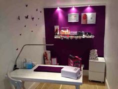 a beauty salon with purple walls and white counter tops, decorated with butterflies on the wall