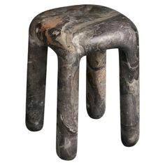 a stool made out of marble with two legs