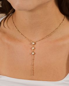 Introducing the Reine Lariat Necklace, a luxurious piece crafted for the sophisticated individual. This elegant necklace features a delicate beaded chain adorned with lustrous pearls, exuding an air of exclusivity and refinement. Elevate any outfit with the timeless style and grace of the Reine Lariat Necklace. Material: 14K gold or rhodium plated brass, freshwater pearls Features: Measures 16" with 2" extender, 3.75" drop, 0.35" pendants, 5mm pearls, 2mm chain, Lead & Nickel free, lobster clasp Lariat Necklace Silver, Pearl Lariat Necklace, Pearl Lariat, Gold Lariat Necklace, Bridal Pearl Necklace, Elegant Necklace, Pearl Earrings Dangle, Elegant Necklaces, Style And Grace