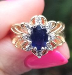 Vintage Sapphire & Diamond ring. Details: Size: US 5 ( Can be sized ) Weight: 4.1 grams Primary stone: Genuine Sapphire Shape: Oval ( Appx. 6mm x 4mm ) Secondary Stone: Diamond Shape: Round Band Width: Appx. 2mm Metal: 14k Yellow Gold Condition: Previously worn/great condition Inside of band is stamped and tested for '14k' gold. All pieces are polished and refinished in our shop. SIZING: Currently this ring is a size 5 but could be sized up or down for an additional small fee if desired by a Yellow Gold Gemstones With Halo Setting For Anniversary, Yellow Gold Cluster Jewelry With Halo Setting, Anniversary Yellow Gold Gemstones With Halo Setting, Gold Gemstones With Halo Setting In Fine Jewelry Style, Exquisite Hallmarked Gemstones For Anniversary, Sapphire Cluster Jewelry For Promise Ring, Classic Sapphire Gemstones With Accent Stones, 14k Gold Sapphire Cluster Jewelry, Sapphire Center Stone Fine Jewelry