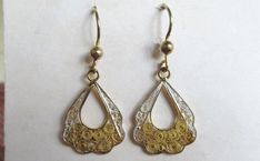 Hi there and welcome to 'In the magpie's nest' For sale - A pair of vintage 60's sterling silver gold plated filigree drop dangle earrings 925 Earring type - Drop/dangle Shape - Fan Measurement - 4cm's (length inc hook) 1.7cm's (width) Backs - Hooks Metal - Sterling silver (gold plated) - 925 - 2.52g Decoration - Filigree Era - 1960's -------------------------------------------------------------------------------------------------- Condition - Good condition - (see pics) Your earrings will come packaged in a gift box -------------------------------------------------------------------------------------------------- Important info - All the items I sell are either vintage or pre-loved and as such will show signs of wear consistent with their age. Items may look larger in photos so please che Vintage Sterling Silver Dangle Jewelry, Filigree Metal Earrings For Anniversary, Anniversary Filigree Earrings, Vintage Filigree Earrings For Anniversary, Filigree Dangle Jewelry For Anniversary, Unique Yellow Gold Filigree Jewelry, Unique Yellow Gold Jewelry With Filigree Details, Metal Hallmarked Drop Earrings, Vintage Teardrop Pierced Earrings