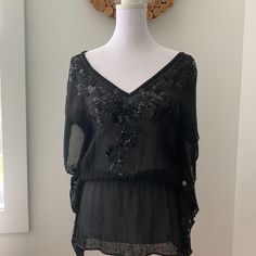 Nwot Vintage Bebe Black Sheer Shirt Size S. Never Worn. 100% Silk With Beautiful Beading. Original Extra Beads Included. It Was Too Long For Me To Ever Wear! You Will Need A Cami Underneath And It Is Better For Ladies That Are A True S Or Xs. Beaded Tops For Night Out In Spring, Beaded Long Sleeve Tops For Night Out, Elegant Beaded Tops For Night Out, Embellished Short Sleeve Tops For Night Out, Chic Beaded Tops For Evening, Black Beaded Top For Night Out, Elegant Beaded Black Tops, Elegant Black Beaded Top, Chic Short Sleeve Embellished Blouse