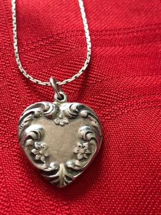 "Antique/Vintage Sterling Silver Heart Pendant with Chain Marked Holland 925 on the Heart and Sterling on the Chain. Signed 925 Sterling Silver Floral Heart Pendant. the beautiful flowered pendant measures 3/4\" wide x just over 3/4\" in length. The pendant is vintage/antique but the chain may be newer, marked STERLING on the clasp. The chain is a beautiful 24\" long with a wonderful link pattern. A very special necklace for a special person who appreciates vintage and antique silver. This was i Vintage Necklace For Valentine's Day, Vintage Heart Necklace With Vintage Charm For Anniversary, Vintage Necklaces With Vintage Charm For Valentine's Day, Vintage Heart Necklace With Charm For Anniversary, Vintage Open Heart Necklace With Heart Charm, Vintage Engraved White Gold Necklace, Vintage Necklaces For Valentine's Day Anniversary, Vintage Heart Necklace For Valentine's Day, Vintage Heart-shaped Necklace With Vintage Charm