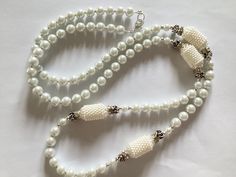 Simple yet beautiful white glass pearl beaded necklace This necklace has been made using glass pearl beads,  silver plated spacer beads, Tibetan silver beads, acrylic barrel beads, rhinestone spacers, Tibetan silver beads and secured with a silver plated lobster clasp  The necklace measures 36" A white pearl memory wire bracelet is available, please see listing photo and follow link  https://www.etsy.com/uk/listing/1235483772/memory-wire-cuff-bracelet-handmade?click_key=df8d97c38f478dc7247939557 Elegant White Beaded Necklaces With Large Beads, Elegant White Necklaces With Large Beads, Elegant White Beaded Necklace With Large Beads, Elegant White Necklace With Large Beads, Elegant Pearl Spacer Beads, Party Pearl Necklace With Silver Beads, White Necklace With Large Beads For Party, Formal White Beaded Necklaces With Round Beads, White Beaded Necklaces For Formal Occasions